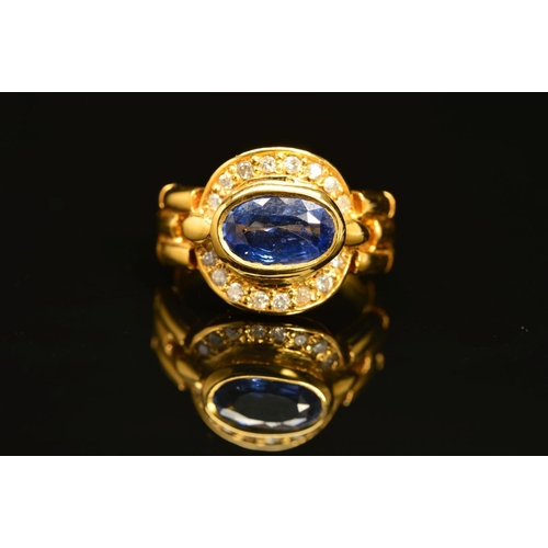 10 - A MODERN SAPPHIRE AND DIAMOND OVAL CLUSTER RING, oval mixed cut sapphire measuring approximately 8.7... 