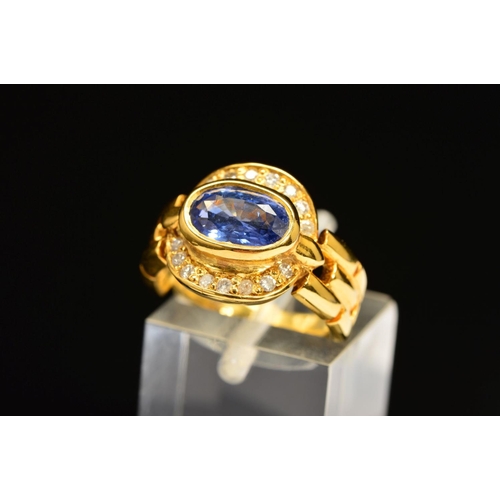 10 - A MODERN SAPPHIRE AND DIAMOND OVAL CLUSTER RING, oval mixed cut sapphire measuring approximately 8.7... 