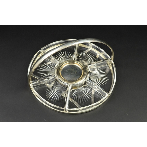 103 - A GEORGE V SILVER CIRCULAR HORS D'OEUVRES TRAY, with fixed carry handle above the open frame, fitted... 