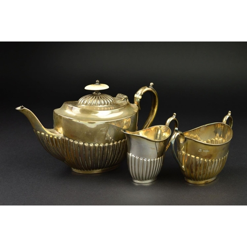 105 - A LATE VICTORIAN SILVER BACHELOR'S THREE PIECE TEASET, of oval form, part reeded to lower half of bo... 