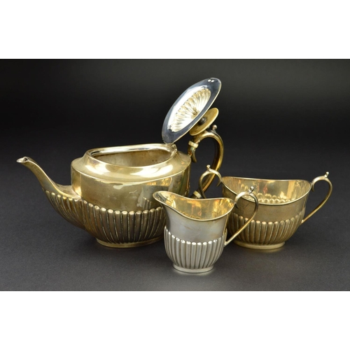 105 - A LATE VICTORIAN SILVER BACHELOR'S THREE PIECE TEASET, of oval form, part reeded to lower half of bo... 