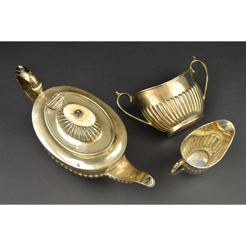 105 - A LATE VICTORIAN SILVER BACHELOR'S THREE PIECE TEASET, of oval form, part reeded to lower half of bo... 