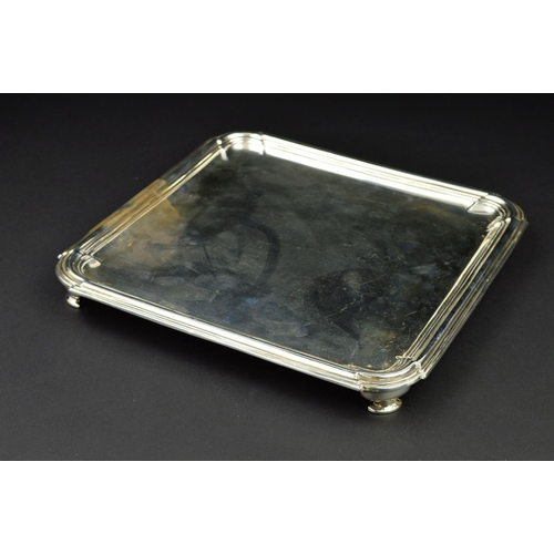 107 - AN EDWARDIAN BRITANNIA STANDARD SILVER SALVER, of square form, rounded corners, stepped banding to b... 