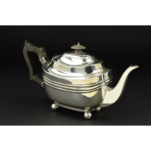 109 - A GEORGE V SILVER BACHELOR'S TEAPOT, of shaped rectangular form, ebonised fitments and on four ball ... 