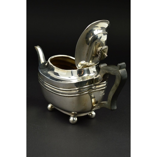 109 - A GEORGE V SILVER BACHELOR'S TEAPOT, of shaped rectangular form, ebonised fitments and on four ball ... 