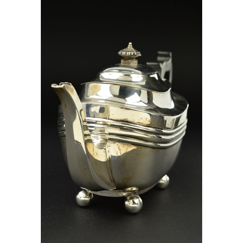 109 - A GEORGE V SILVER BACHELOR'S TEAPOT, of shaped rectangular form, ebonised fitments and on four ball ... 