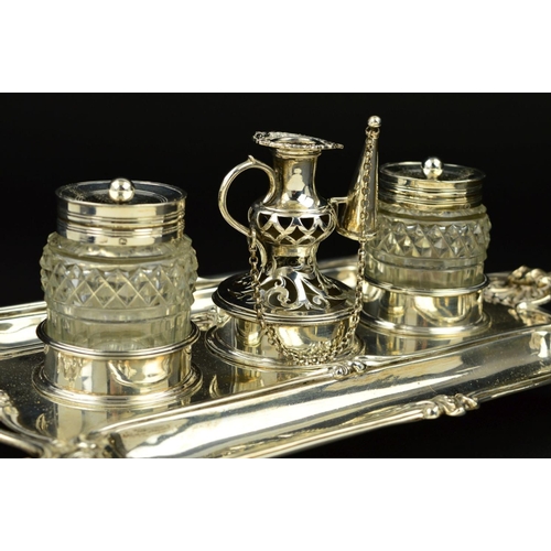 112 - A GEORGE III SILVER SHAPED RECTANGULAR INKSTAND, fitted with a central taperstick with removable sco... 