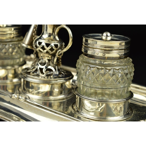 112 - A GEORGE III SILVER SHAPED RECTANGULAR INKSTAND, fitted with a central taperstick with removable sco... 