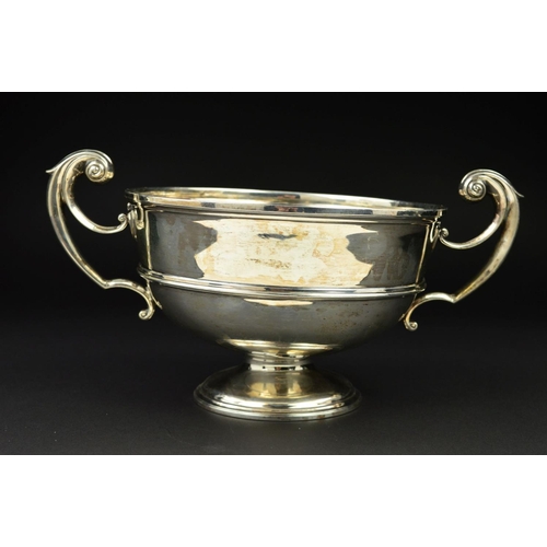 120 - A LATE VICTORIAN SILVER TWIN HANDLED TROPHY CUP, of circular form, cast scrolling handles, the cup w... 