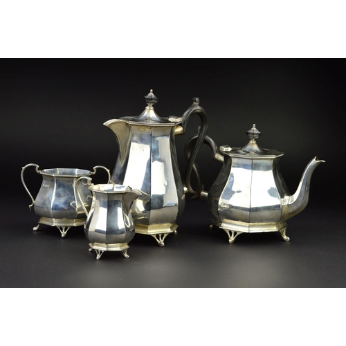 122 - A GEORGE V SILVER FOUR PIECE TEA SERVICE, of octagonal baluster form, 'S' scroll handles, ebony fitm... 