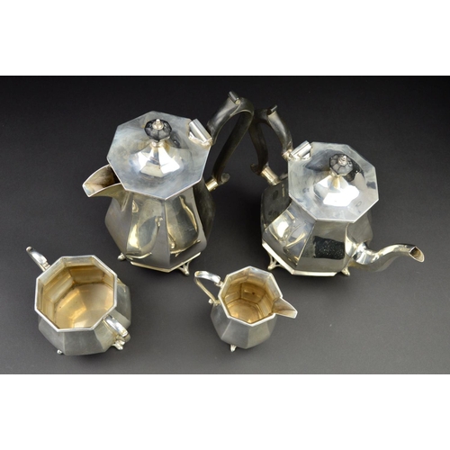 122 - A GEORGE V SILVER FOUR PIECE TEA SERVICE, of octagonal baluster form, 'S' scroll handles, ebony fitm... 