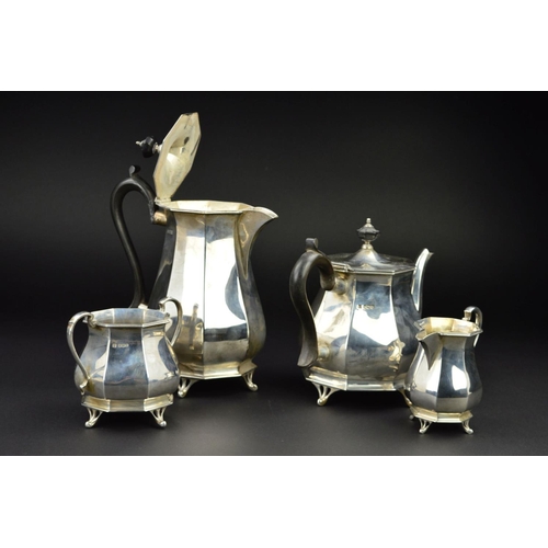 122 - A GEORGE V SILVER FOUR PIECE TEA SERVICE, of octagonal baluster form, 'S' scroll handles, ebony fitm... 