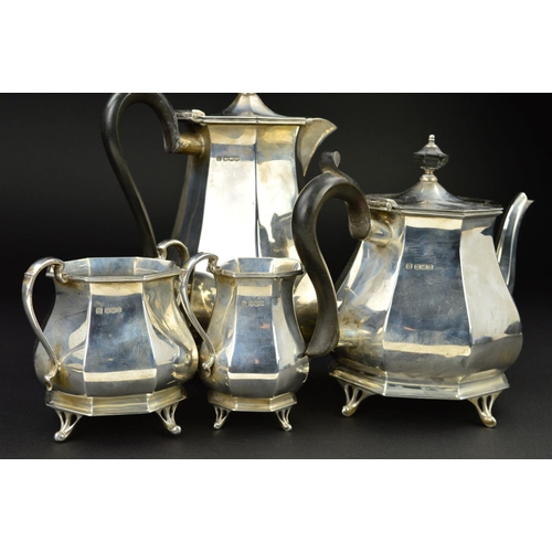 122 - A GEORGE V SILVER FOUR PIECE TEA SERVICE, of octagonal baluster form, 'S' scroll handles, ebony fitm... 