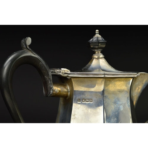 122 - A GEORGE V SILVER FOUR PIECE TEA SERVICE, of octagonal baluster form, 'S' scroll handles, ebony fitm... 