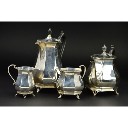 122 - A GEORGE V SILVER FOUR PIECE TEA SERVICE, of octagonal baluster form, 'S' scroll handles, ebony fitm... 