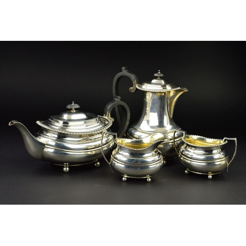 126 - A GEORGE V SILVER FOUR PIECE TEA SERVICE, of oval form, gadrooned rims, over a lobed girdle, on four... 