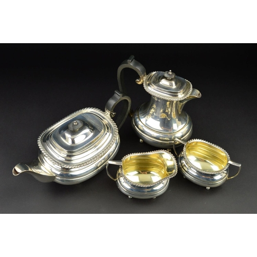 126 - A GEORGE V SILVER FOUR PIECE TEA SERVICE, of oval form, gadrooned rims, over a lobed girdle, on four... 