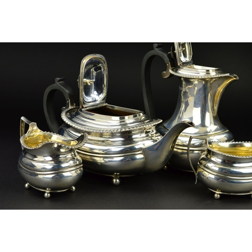 126 - A GEORGE V SILVER FOUR PIECE TEA SERVICE, of oval form, gadrooned rims, over a lobed girdle, on four... 