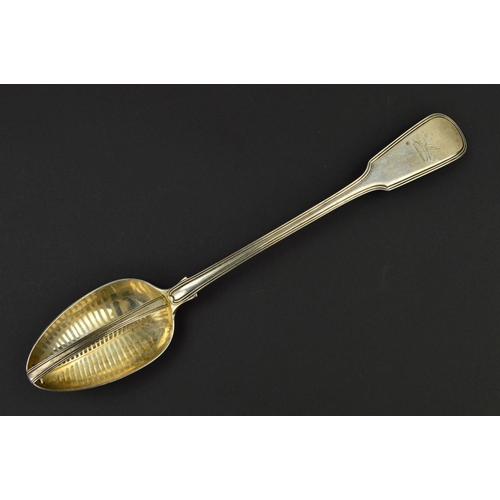 127 - A GEORGE IV SILVER FIDDLE AND THREAD PATTERN GRAVY STRAINING SPOON, engraved crest, the bowl with pi... 