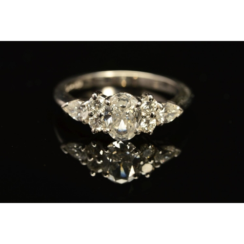 13 - A MODERN PLATINUM DIAMOND DRESS RING, centring on an oval modern brilliant cut diamond, accompanied ... 