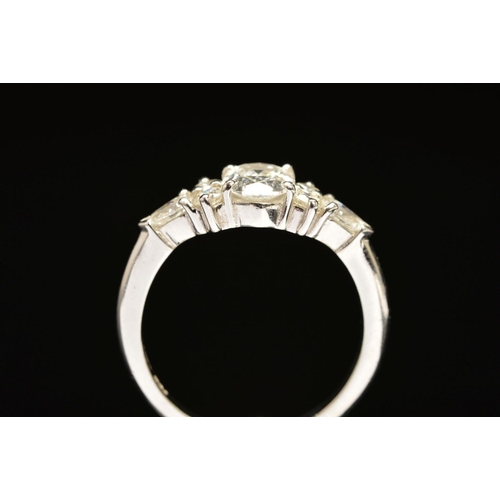 13 - A MODERN PLATINUM DIAMOND DRESS RING, centring on an oval modern brilliant cut diamond, accompanied ... 