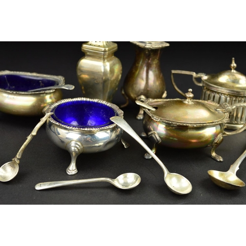 132 - A PARCEL OF SILVER CRUET ITEMS, including a three piece set of shaped oval form with cast rims and o... 