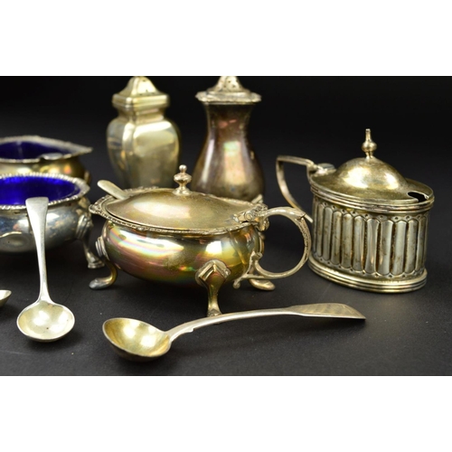 132 - A PARCEL OF SILVER CRUET ITEMS, including a three piece set of shaped oval form with cast rims and o... 