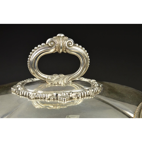 137 - A GRADUATED SET OF TWO VICTORIAN SILVER PLATED OVAL MEAT DOMES, beaded and foliate cast handles, bea... 