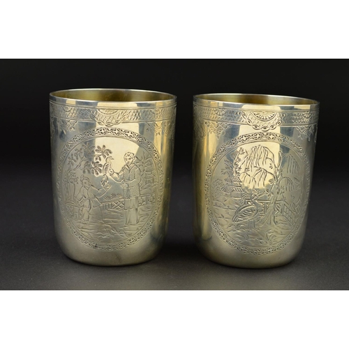 142 - A PAIR OF VICTORIAN SILVER CYLINDRICAL BEAKERS, gilt interiors, engraved bands to the rims with loze... 