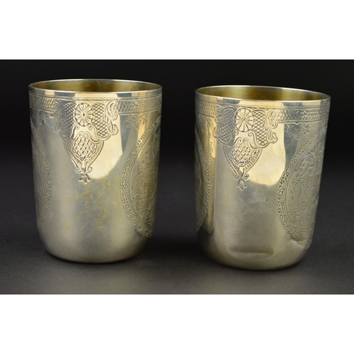 142 - A PAIR OF VICTORIAN SILVER CYLINDRICAL BEAKERS, gilt interiors, engraved bands to the rims with loze... 