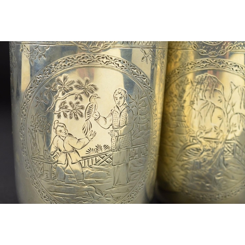 142 - A PAIR OF VICTORIAN SILVER CYLINDRICAL BEAKERS, gilt interiors, engraved bands to the rims with loze... 