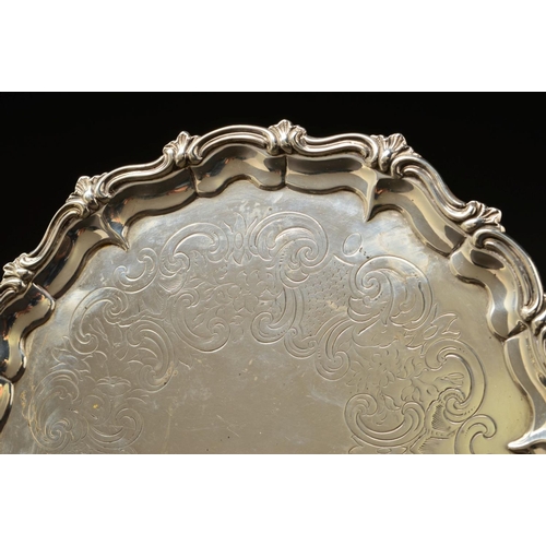 148 - A VICTORIAN SILVER SALVER, of circular form, with foliate cast wavy rim above pie crust border, foli... 