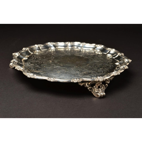 148 - A VICTORIAN SILVER SALVER, of circular form, with foliate cast wavy rim above pie crust border, foli... 