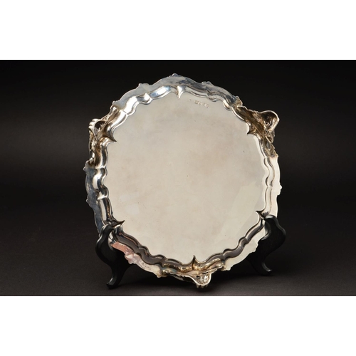 148 - A VICTORIAN SILVER SALVER, of circular form, with foliate cast wavy rim above pie crust border, foli... 