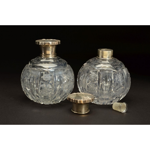 153 - A PAIR OF EARLY 20TH CENTURY SPHERICAL GLASS SCENT BOTTLES, with white metal pull off covers stamped... 