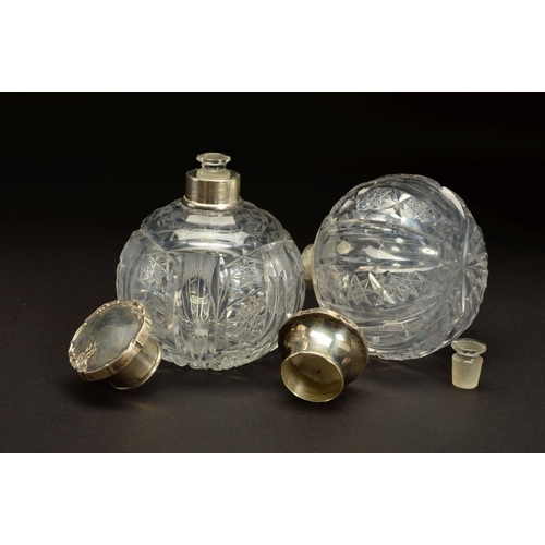 153 - A PAIR OF EARLY 20TH CENTURY SPHERICAL GLASS SCENT BOTTLES, with white metal pull off covers stamped... 