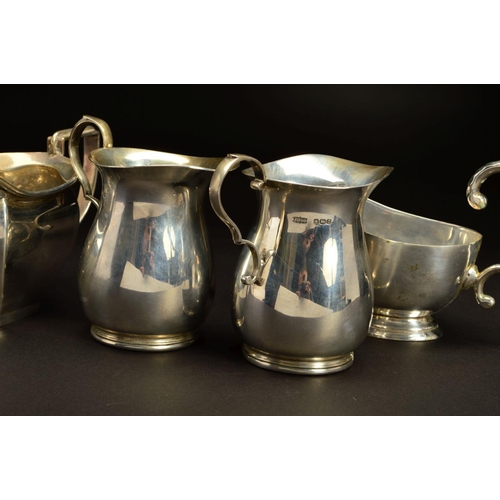 166 - A PAIR OF GEORGE VI SILVER BALUSTER CREAM JUGS, 'S' scroll handles, makers James Dixon & Sons Ltd, S... 