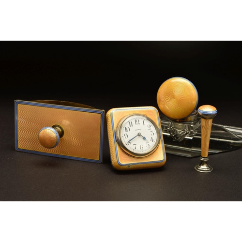 167 - A GEORGE V SILVER AND APRICOT ENAMEL DESK SET, comprising rectangular easel back desk clock, seal, g... 