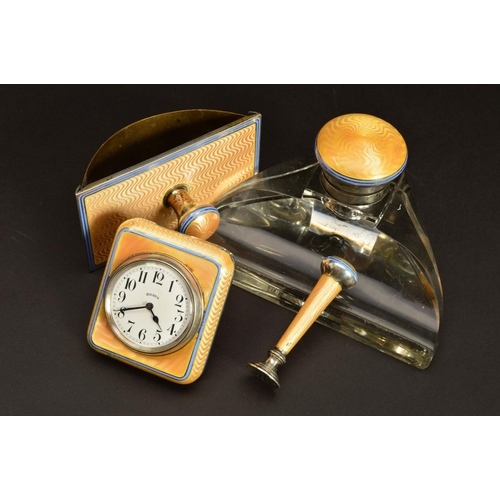 167 - A GEORGE V SILVER AND APRICOT ENAMEL DESK SET, comprising rectangular easel back desk clock, seal, g... 