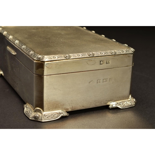 169 - AN ELIZABETH II SILVER RECTANGULAR CIGARETTE BOX, Celtic design to lid and feet, engine turned top, ... 