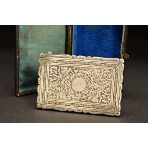 176 - A VICTORIAN SILVER CARD CASE, of shaped rectangular form, foliate engraved decoration, blind circula... 