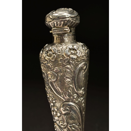 182 - A LATE VICTORIAN SILVER SCENT FLASK, of flattened conical form, foliate embossed decoration througho... 