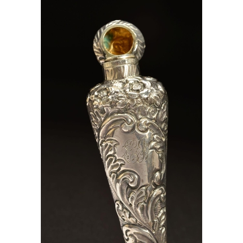 182 - A LATE VICTORIAN SILVER SCENT FLASK, of flattened conical form, foliate embossed decoration througho... 