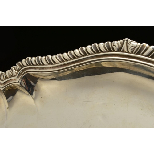 189 - A GEORGE II SILVER MEAT/SERVING PLATTER, of shaped oval form, gadrooned and stepped rim, the centre ... 