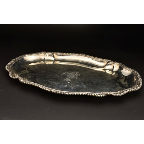 189 - A GEORGE II SILVER MEAT/SERVING PLATTER, of shaped oval form, gadrooned and stepped rim, the centre ... 