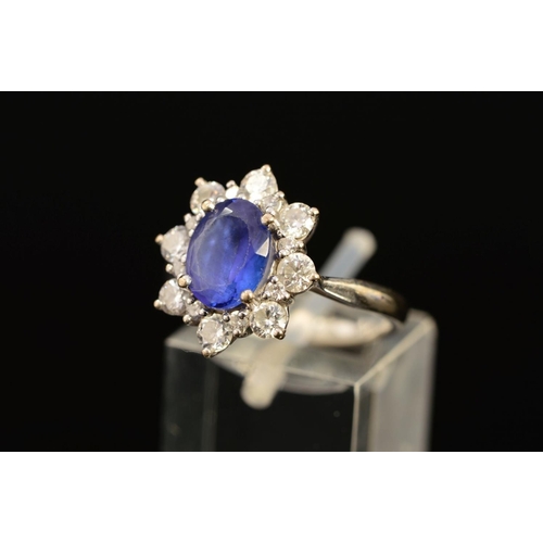 2 - A MODERN 18CT WHITE GOLD TANZANITE AND DIAMOND OVAL CLUSTER RING, oval mixed cut tanzanite measuring... 