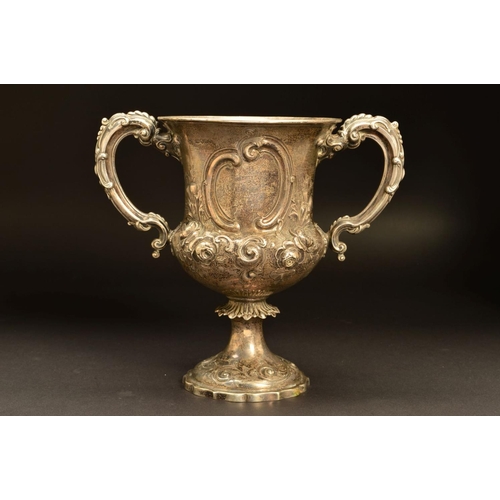 200 - A VICTORIAN SILVER TWIN HANDLED TROPHY CUP, of urn form, repousse decorated with roses and thistles,... 