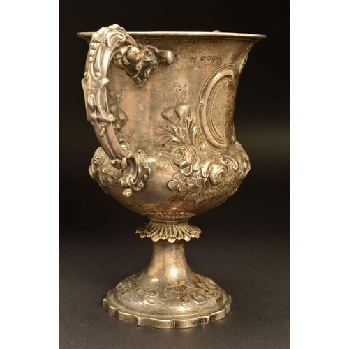 200 - A VICTORIAN SILVER TWIN HANDLED TROPHY CUP, of urn form, repousse decorated with roses and thistles,... 