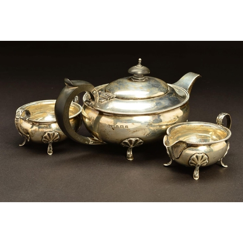 202 - A GEORGE V SILVER THREE PIECE BACHELOR'S TEASET, of oval form, egg and tongue rims, on four cabriole... 