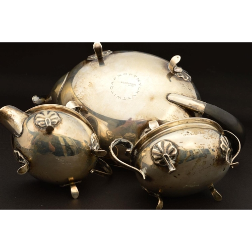 202 - A GEORGE V SILVER THREE PIECE BACHELOR'S TEASET, of oval form, egg and tongue rims, on four cabriole... 